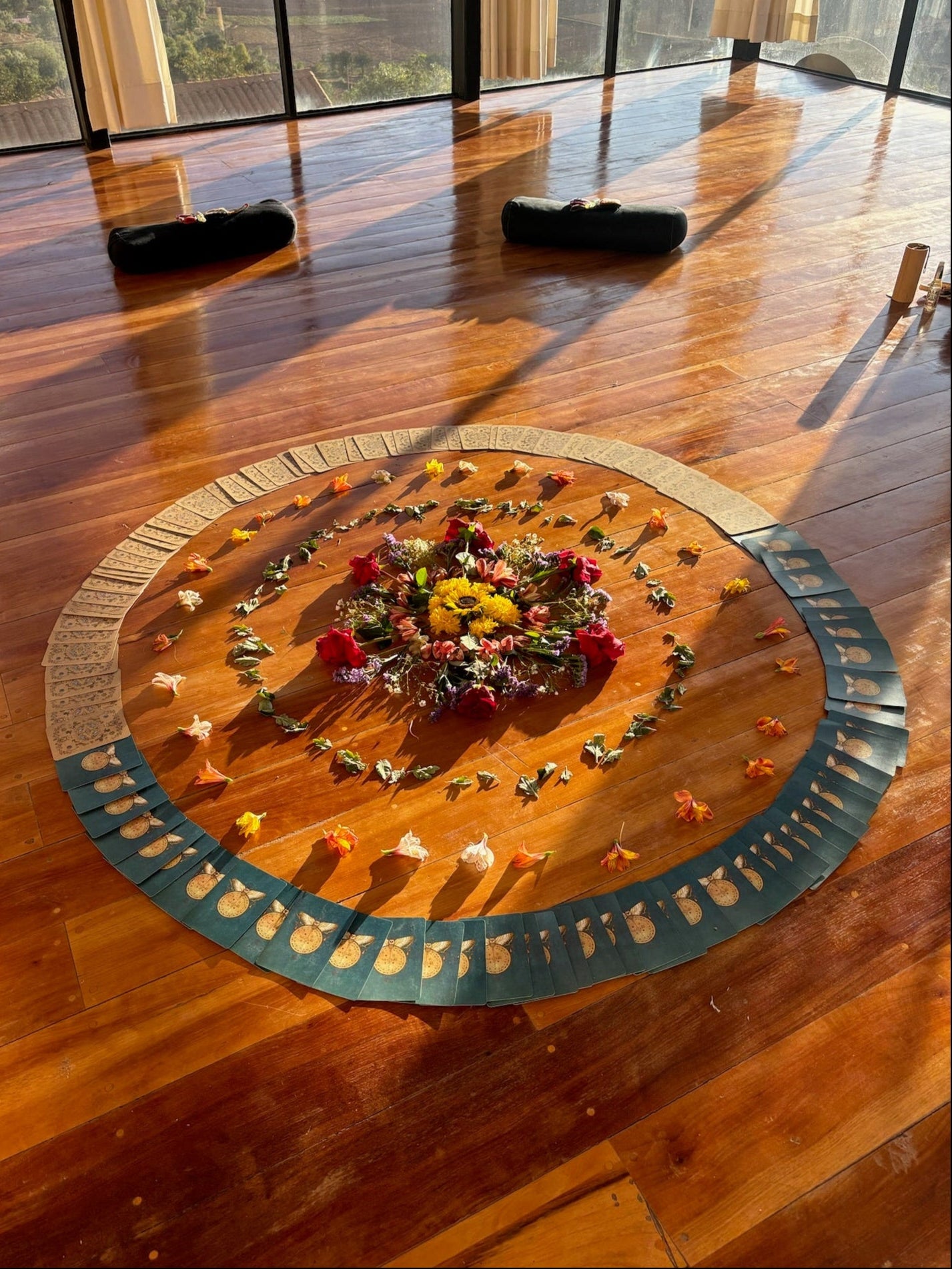 Decorative floral arrangement on a wooden floor with circular pattern